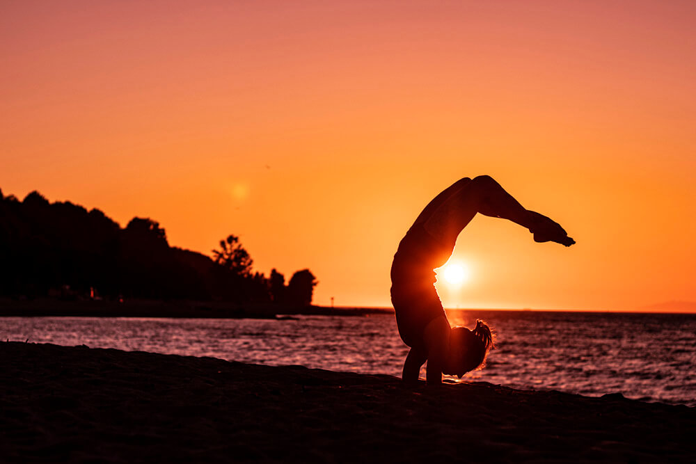 Young woman standing in Scorpion pose, vrischikasana, practicing yoga Stock  Photo - Alamy
